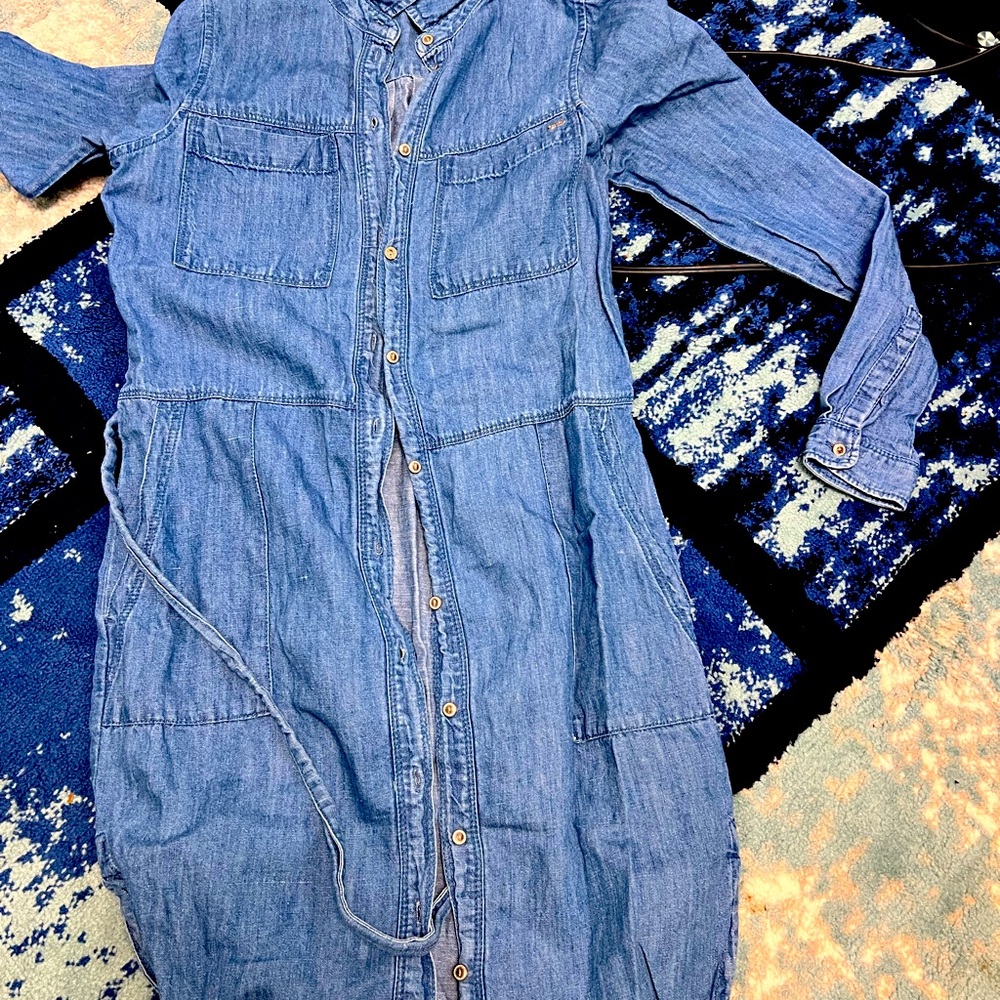 Blue denim knee length dress with long sleeves.